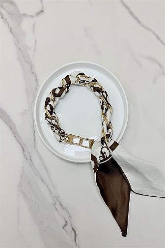 Brown and white patterned scarf wrapped keychain.
