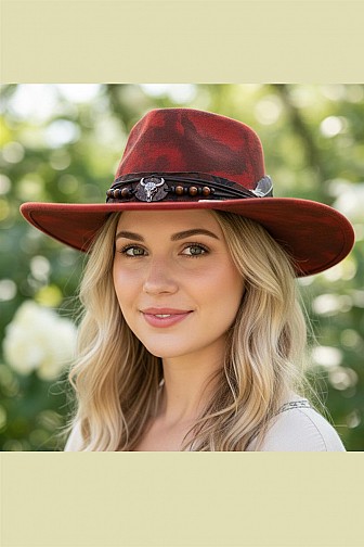 WESTERN-STYLE DISTRESSED RUST FELT HAT WITH A BEADED BAND, FEATHER, AND BULL SKULL ACCENT